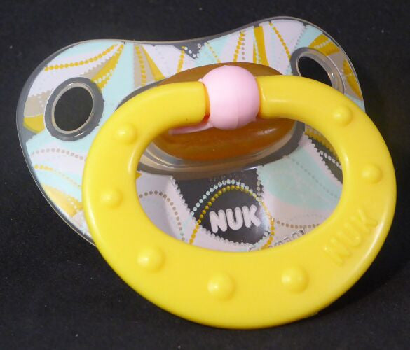Yellow and Pink NUK Pacifier with swirly Pattern