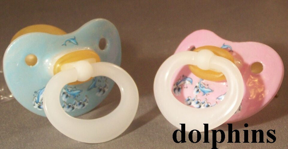 NUK Pacifier decorated with dolphins.