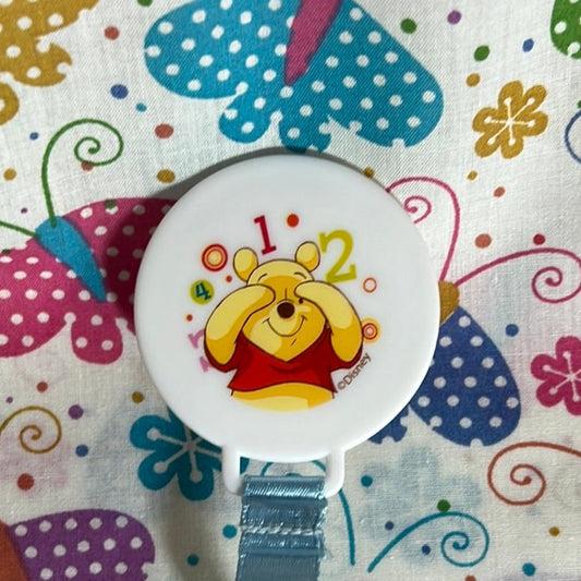 Whinnie the Pooh playing pikaboo with numbers pacifier clip